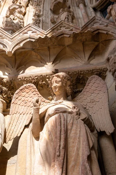 stock image View in details on gothic Roman Catholic cathedral church Notre-Dame in central part of old French city Reims, France, smiling angel