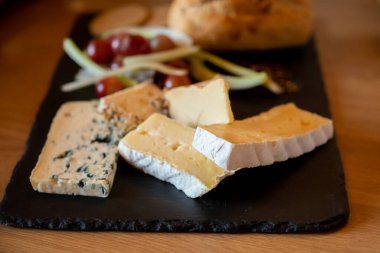 Tasting of fresh farmers scottish cheeses smoked cheddar, stilton, blue cheese, brie in Edinburgh, UK