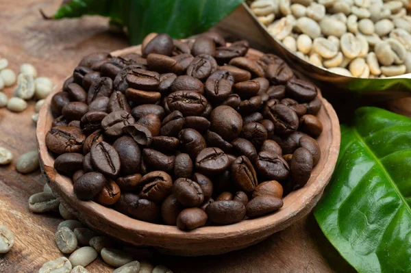 Green and roasted coffee beans from South America coffee producing region, from Colombia and Brazil with mountain ranges and climate ideal for coffee growing, close up