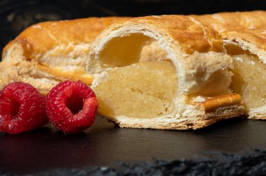 Taze fırında Hollanda baharatlı kurabiyeler, puf böreklerinden, sonbahar renklerinde bademlerle koyu taşlara yakın.