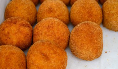 Traditional street food in UK, stuffed fried Scotch eggs with breadcrumbs close up