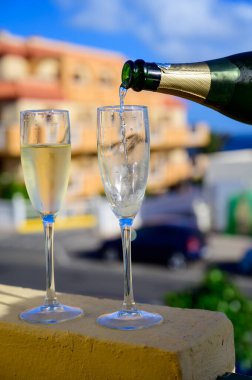 Dinner party, drinking of cava or champagne sparkling wine in vacation resort Caleta Fuste, Fuerteventura, Canary islands winter sun vacation, Spain
