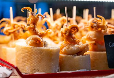 Bask ülkesinin tipik aperatifleri, küçük ekmek parçaları, deniz ürünleri, yumurta, peynir, San-Sebastian veya Bilbao, İspanya 'da barda servis edilen jamon şişleriyle kapatılıyor.