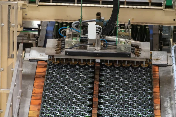 Production of cremant sparkling wine in Burgundy, France. Automatically powered bottling, riddling and corking lines on factory.