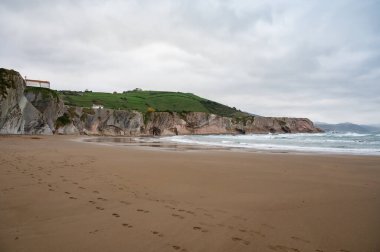 View on sandy beach, rocks and Atlantic ocean in Zumaia touristic ciry, Basque Country, Spain at winter