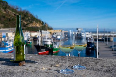 Pouring of txakoli or chacol slightly sparkling very dry white wine produced in Spanish Basque Country in typical pinchos bar in old part of San Sebastian or Donostia