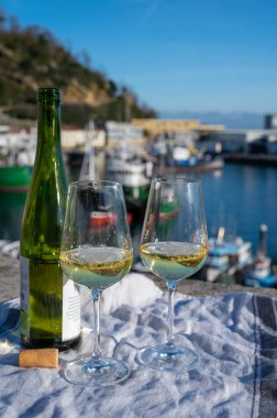 Pouring of txakoli or chacol slightly sparkling very dry white wine produced in Spanish Basque Country in typical pinchos bar in old part of San Sebastian or Donostia