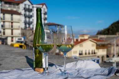 Pouring of txakoli or chacol slightly sparkling very dry white wine produced in Spanish Basque Country in typical pinchos bar in old part of San Sebastian or Donostia