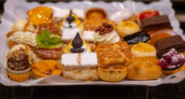 Lezzetli taze fırınlanmış renkli pastalar, kremalı turtalar ve meyveler Bilbao, Bask Bölgesi, İspanya 'daki ziyafet fırınında sergileniyor.