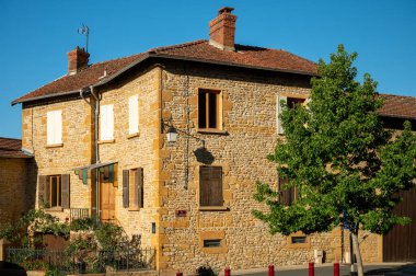 Wine making region Beaujolais Pierre dorees wioth yellow houses and hilly vineyards, France in summer