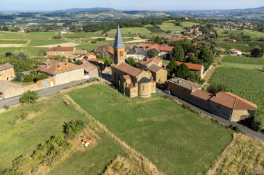 Wine making region Beaujolais Pierre dorees wioth yellow houses and hilly vineyards, aerial view, France in summer