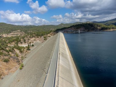 Aerial view on freshwater lake with dam for irrigation and drinking in hilly centre of dry, sunny Cyprus island