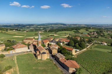 Wine making region Beaujolais Pierre dorees wioth yellow houses and hilly vineyards, aerial view, France in summer