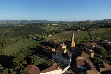 Wine making region Beaujolais Pierre dorees wioth yellow houses and hilly vineyards, aerial view, France in summer