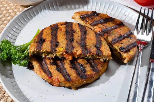 Barbecue grilled tasty vegan and vegetarian burgers made from fresh vegetables and dried legumes and beans, ready to eat