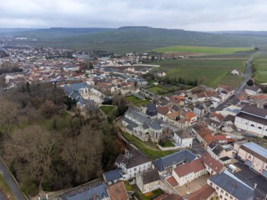 Aerial panoramic winter view on cloudy landscape, hilly vineyards and Marne river near Ay gran cru champagne village near Epernay, wine production in France