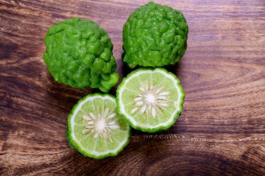 Citrus hystrix, green kaffir lime or makrut lime, citrus fruit native to tropical Southeast Asia. Fruit and leaves used in Southeast Asian cuisine, essential oil is used in perfumery for intense citrus fragrance.