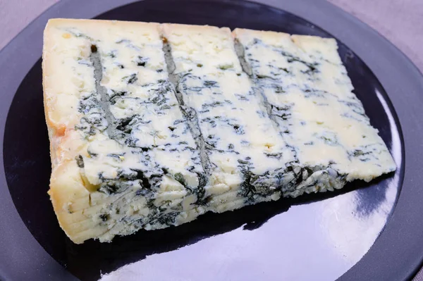 Italian food, buttery or firm blue cheese made from cow milk in Gorgonzola, Milan, Italy close up