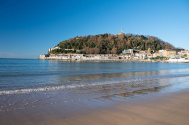 White sandy La Concha beach in central part of Donostia or San Sebastian city, Basque Country, Spain in sunny day