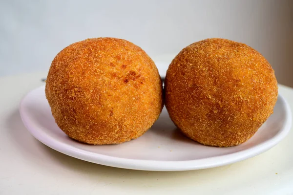 Traditional street food in UK, stuffed fried Scotch eggs with breadcrumbs close up