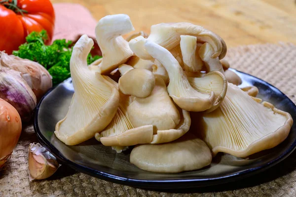 Tasty vegetarian food, fresh organic Pleurotus ostreatus, or oyster mushrooms, hiratake, or pearl oyster mushrooms close up