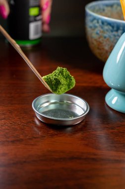 Doğu Asya ve Japonya 'da tüketilen özel yetişmiş ve işlenmiş yeşil çay yapraklarının ince toprak tozundan yeşil kibrit çayı hazırlama.