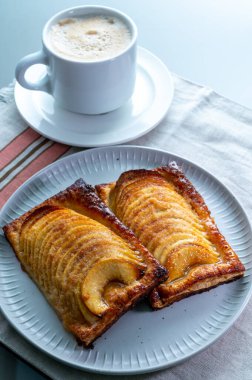 Breakfast with black coffee and sweet French dessert, baked apple cake, Normandy region, France, close up