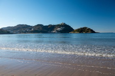 White sandy La Concha beach in central part of Donostia or San Sebastian city, Basque Country, Spain in sunny day