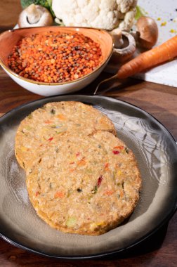 Uncooked fresh vegan and vegetarian burgers made from fresh vegetables and dried legumes and beans, ready to barbecue grill