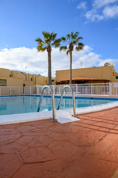 Blue swummung pool. Winter sea and sun vacation in Caleta de Fuste touristic village on Fuerteventura, Canary islands, Spain