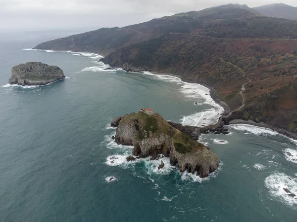 Atlantic ocean coastline near famous landmark and film location in North of Spain, ocean islet with chapel San juan de Gaztelugatxe, Basque Country, Spain in wintertime