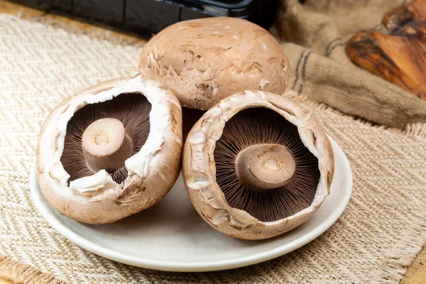 Tasty vegetarian food, large brown champignons Agaricus bisporus portobello mushrooms close up