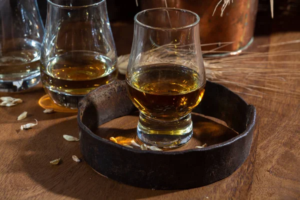 stock image Speyside scotch whisky tasting glasses on old dark wooden vintage table with barley grains close up