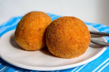 Traditional street food in UK, stuffed fried Scotch eggs with breadcrumbs close up