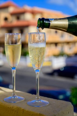 Dinner party, drinking of cava or champagne sparkling wine in vacation resort Caleta Fuste, Fuerteventura, Canary islands winter sun vacation, Spain