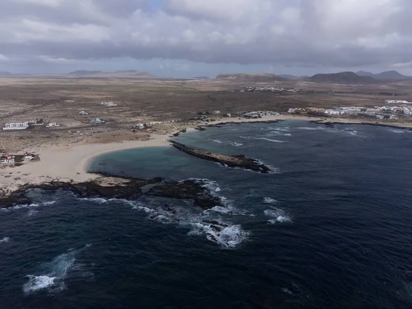 stock image Aerial view on white sandy dunes, blue ocean water on La Concha beach, El Cotillo surfers village, Fuerteventura, Canary islands, winter in Spain