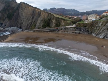 View on sandy beach, rocks and Atlantic ocean in Zumaia touristic ciry, Basque Country, Spain at winter