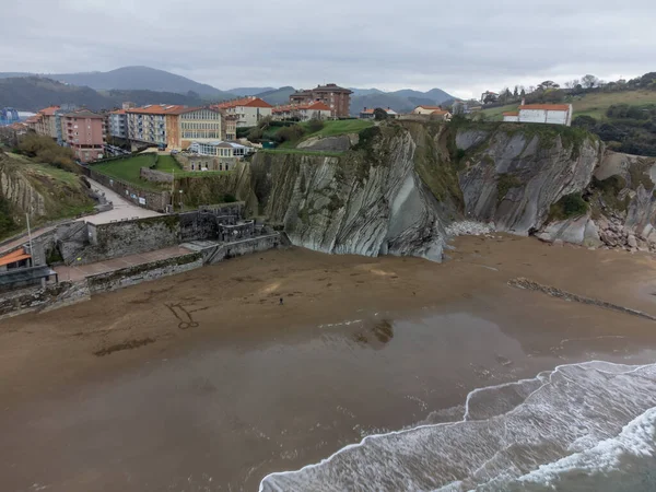 View on sandy beach, rocks and Atlantic ocean in Zumaia touristic ciry, Basque Country, Spain at winter