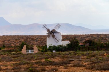 Old traditional Canarian grain wind mill near Antigua village, countryside landscape of Fuerteventura island, Canary islands, Spain