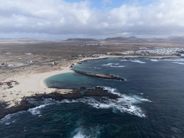 stock image Aerial view on white sandy dunes, blue ocean water on La Concha beach, El Cotillo surfers village, Fuerteventura, Canary islands, winter in Spain