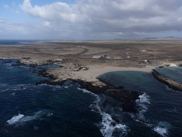 stock image Aerial view on white sandy dunes, blue ocean water on La Concha beach, El Cotillo surfers village, Fuerteventura, Canary islands, winter in Spain