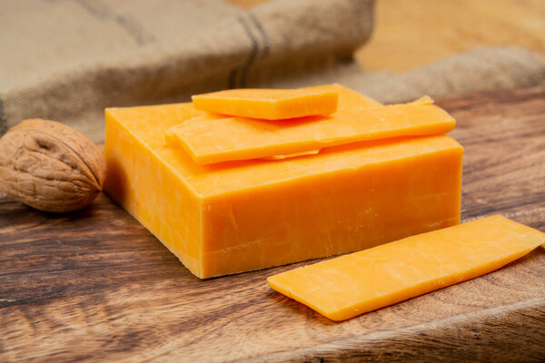 Leicestershire or cheddar cheese or red leicester, British hard cheese made from cow milk close up