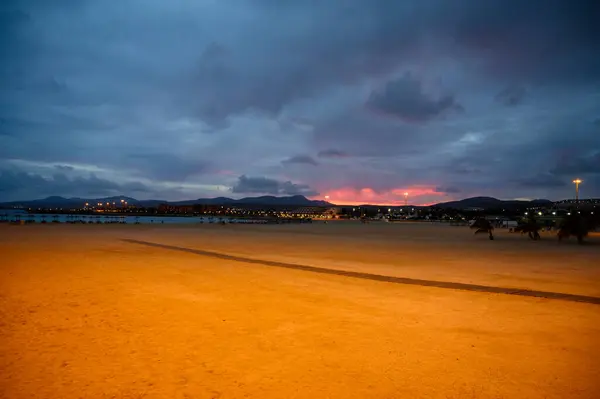 stock image Sandy beach after sunset. Winter sea and sun vacation in Caleta de Fuste touristic village on Fuerteventura, Canary islands, Spain