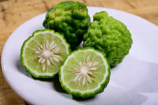 Citrus hystrix, green kaffir lime or makrut lime, citrus fruit native to tropical Southeast Asia. Fruit and leaves used in Southeast Asian cuisine, essential oil is used in perfumery for intense citrus fragrance.