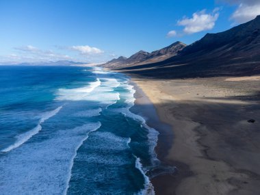 Fuerteventura, Kanarya Adaları 'ndaki sıradağların arkasına gizlenmiş altın kumlu kumlu kumlu plaja ulaşmak zor.