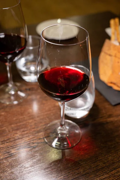 stock image Dinner with glass of dry red wine in Italian osteria restaurant close up