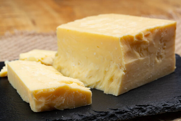 British cheeses collection, English matured smoked cheddar cheese close up