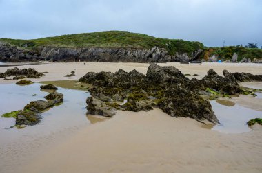 Celorio 'daki Playa de Borizo' daki kayalara bakın. Kuzey İspanya, Asturias 'ın yeşil kıyıları. Beyaz kumlu plajlar, uçurumlar, gizli mağaralar, yeşil tarlalar, ormanlar ve dağlar..