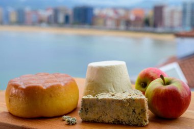 Asturian peynirleri, Pria 'dan tütsülenmiş inek peyniri, Arenas' tan mavi peynir ve Pitu, Asturias 'tan beyaz rebollin, İspanya' nın Gijon kentindeki San Lorenzo plajında servis edildi.