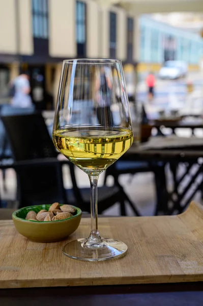 stock image Drinking of cold spanish rueda verdejo white wine with view on old street of Oviedo, Spain